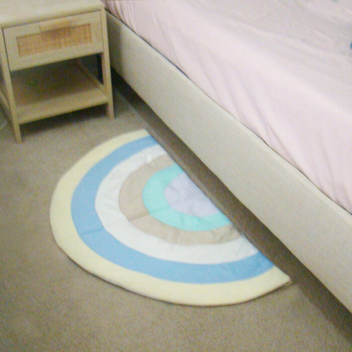 Quilted Rainbow bed foot mat, non-slip back.